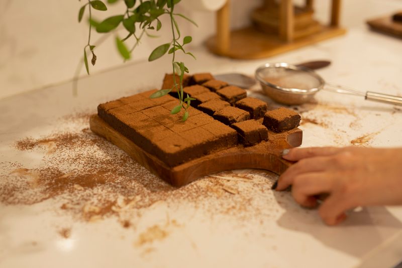 Brownie Bites dusted with powdered sugar on a wooden board